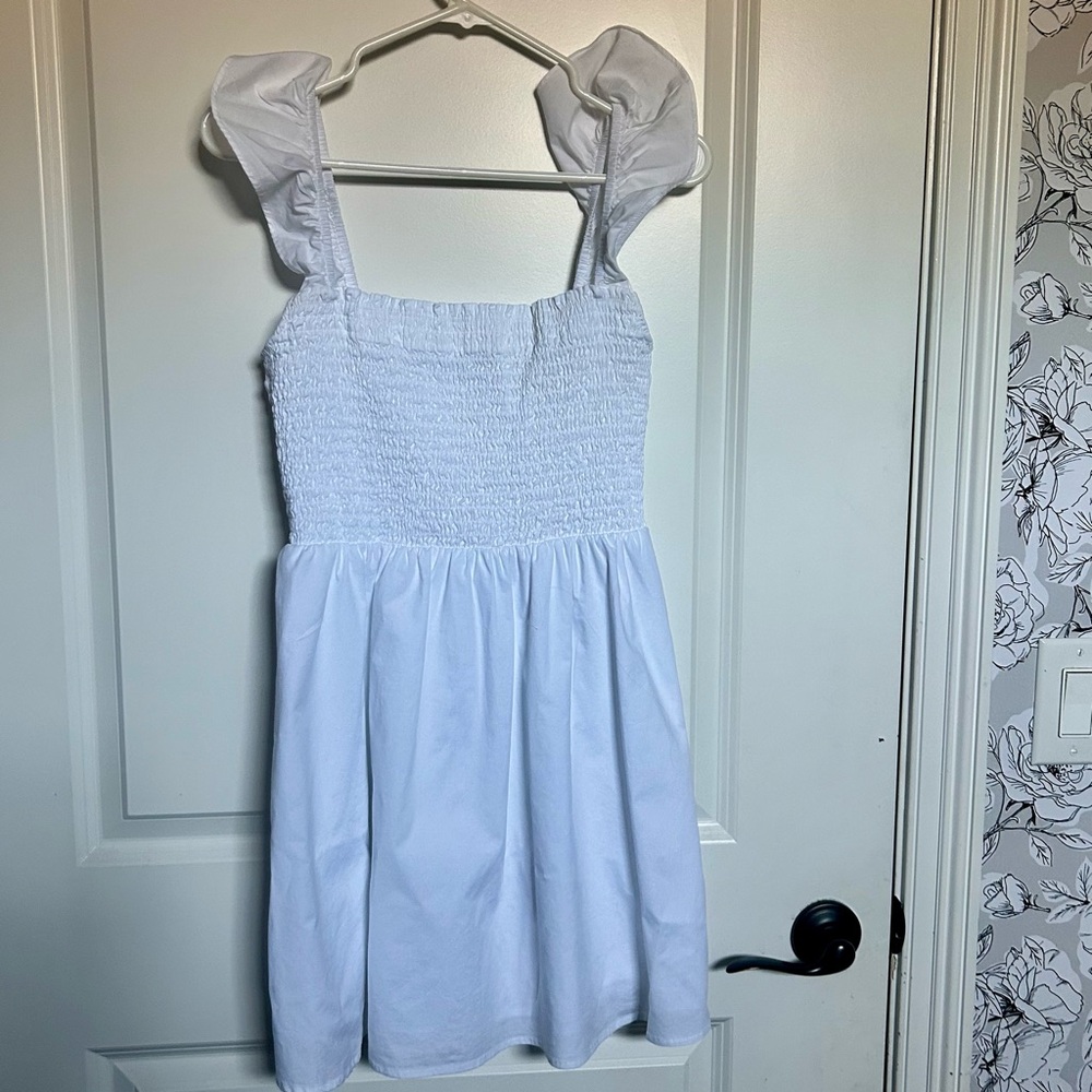 White Dress with Ruffled Sleeves and tie bow in back.